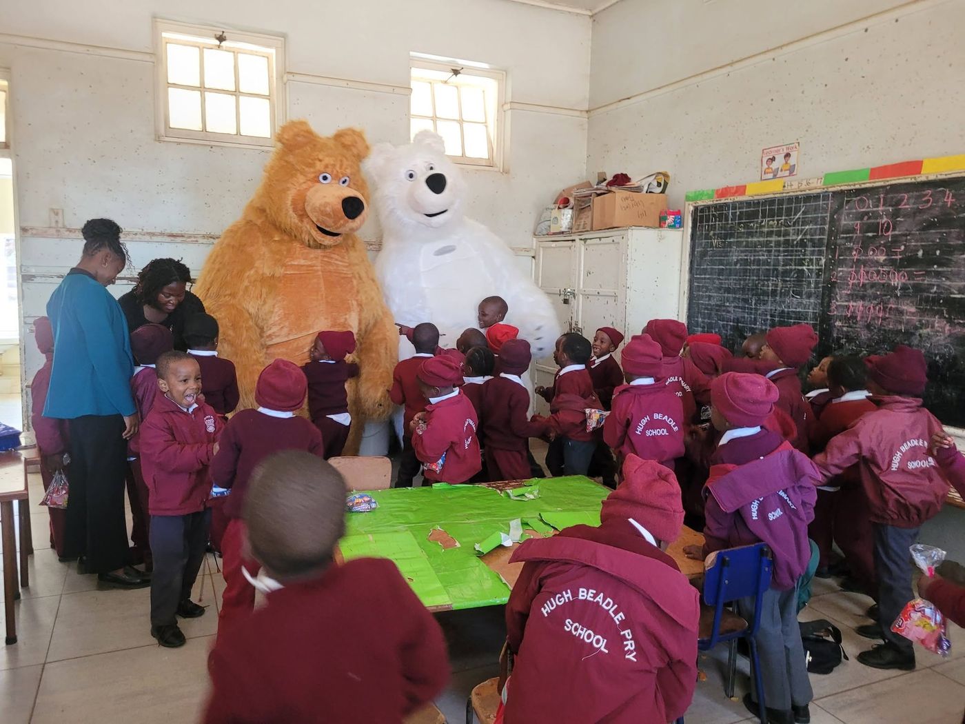 Mascots visiting a classroom full of excited school children